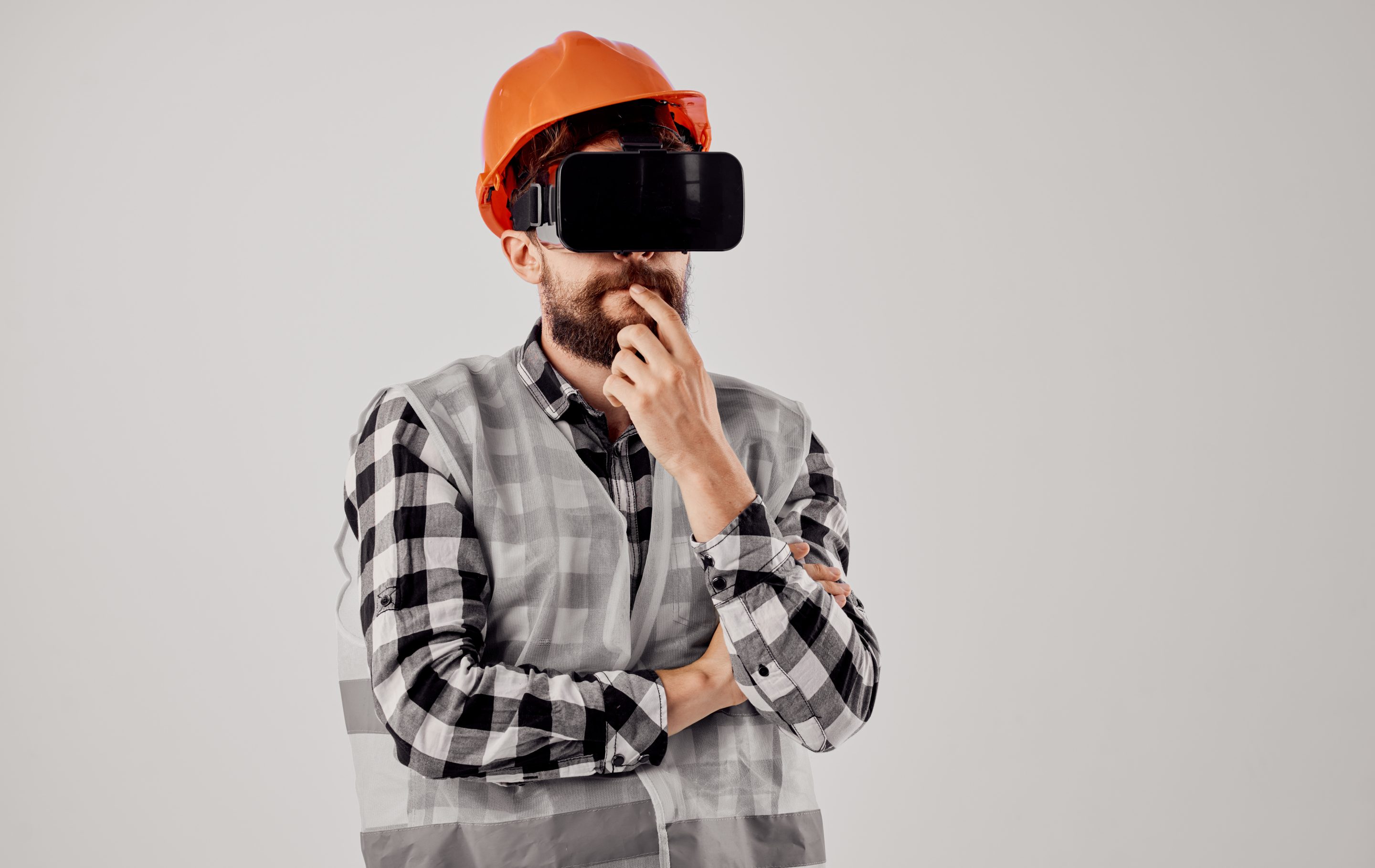 Civil engineer wearing 3D virtual reality glasses and an orange hard hat on his head Employer Sponsored Visas