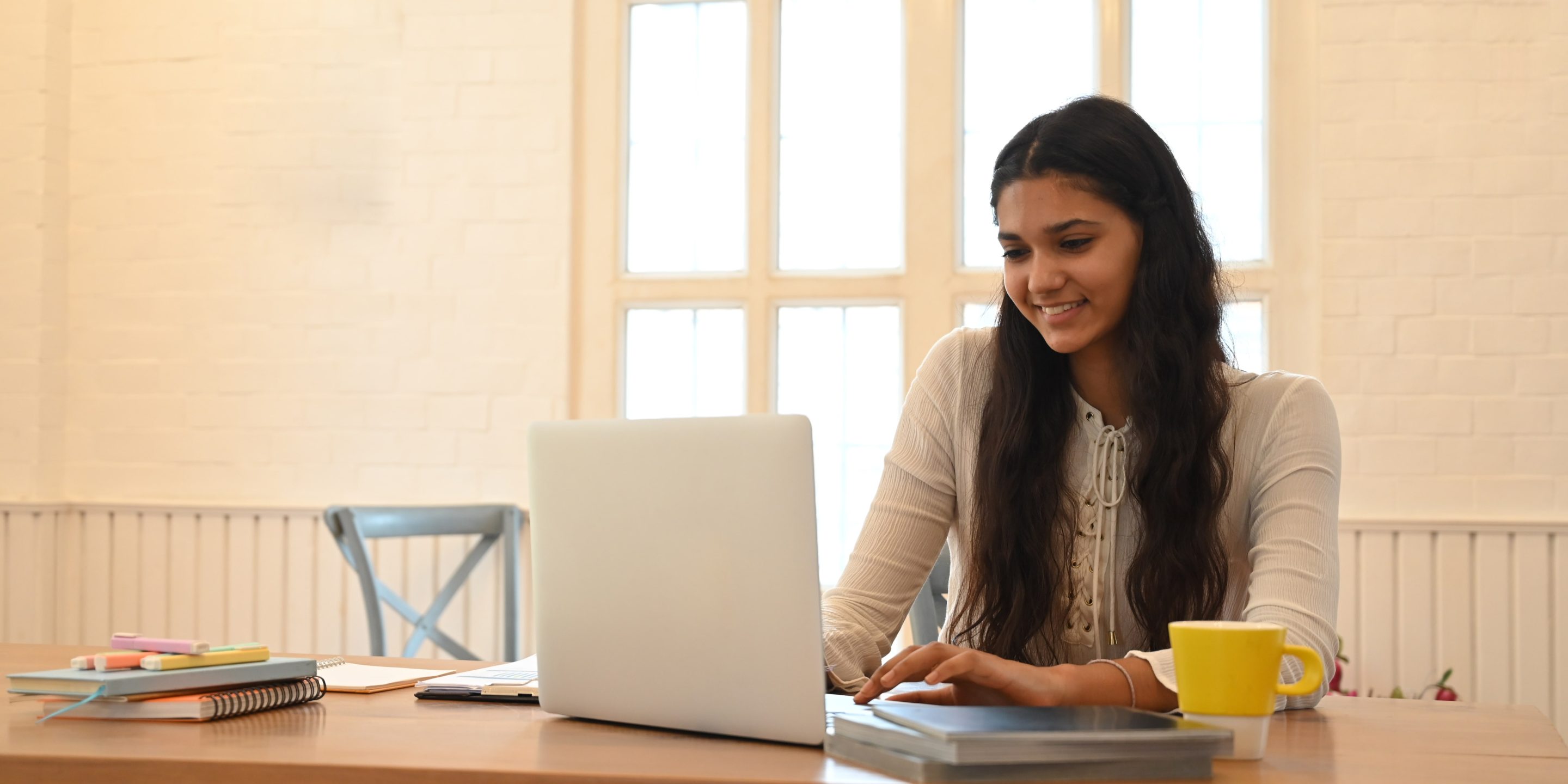 university-student-is-learning-lessons-online-while-sitting-wooden-working-desk