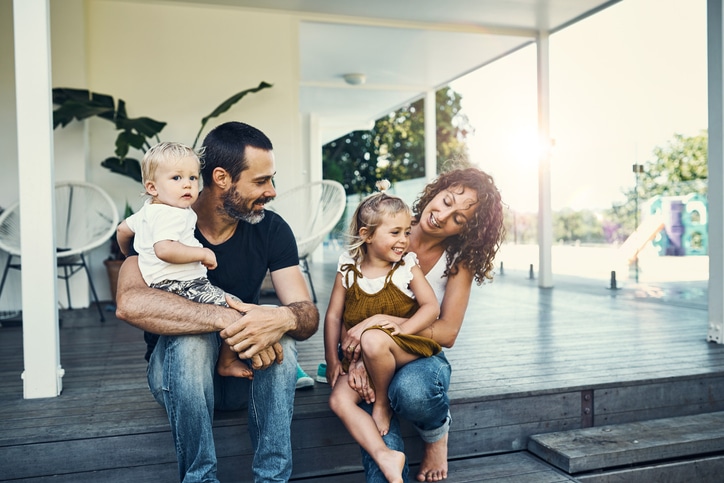 VEVS Global - Family Visa Services A family holding their children and smiling after being granted their family visa thanks to the migration services of VEVS Global